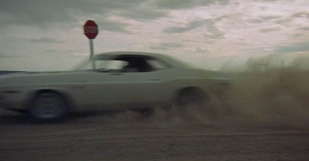Kowalski's Dodge Challenger blowing past a stop sign